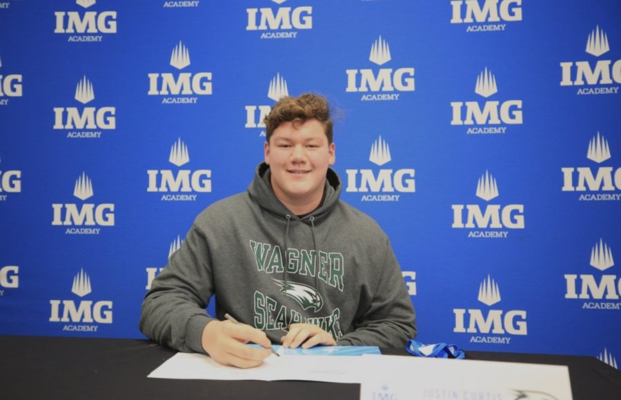 On to New York! After considering many offers, Justin Curtis signs to continue his football career at Wagner College. / Photo used with permission from Justin Curtis.
