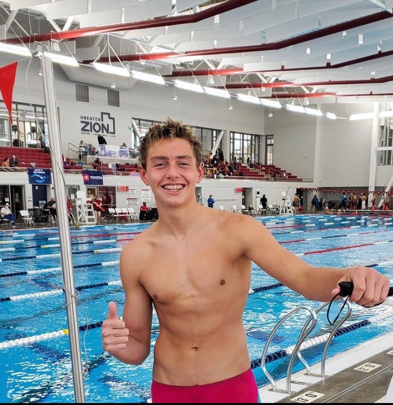 Kyle Brill poses with a grin after completing a swim meet. / Photo used with permission from Kyle Brill.